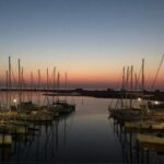 Blick auf einen Yachthafen an der Ostsee im Sonnenuntergang