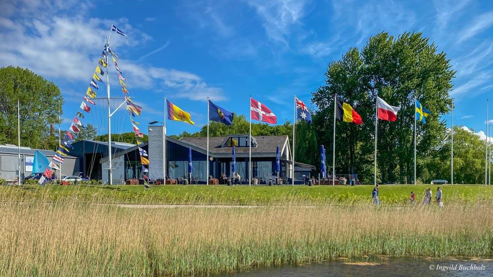 Vor dem Clubhaus des Flensburger Segel-Clubs wehen sieben verschiedene Nationalflaggen an den Flaggenmasten