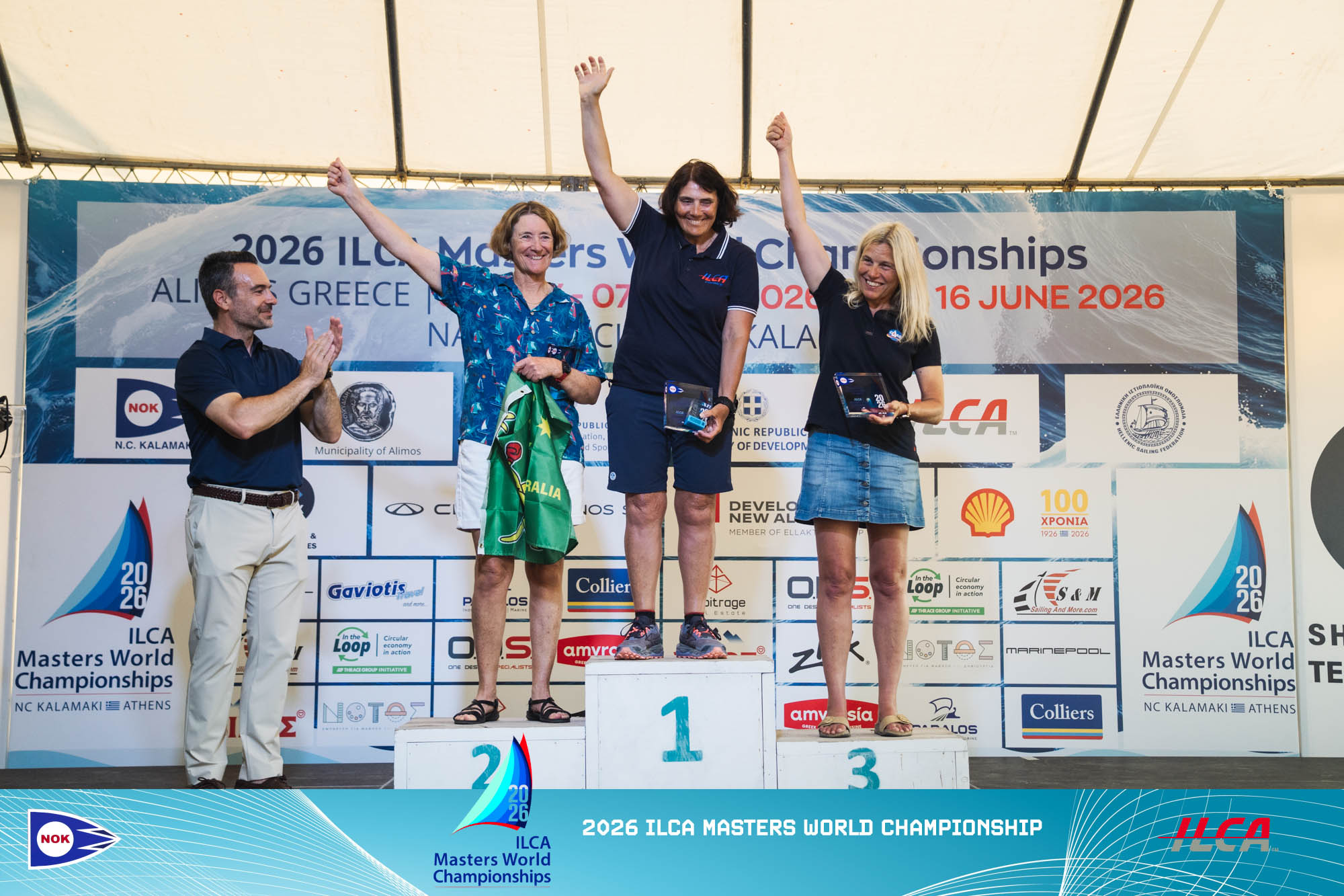 Drei Frauen stehen auf einem Siegerpodest nach einer Segelregatta.
